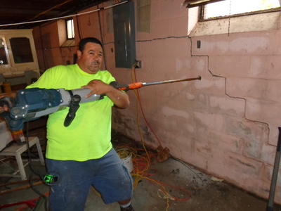 Quality Foundation Repair hard at work repairing bowed and cracked walls in Omaha, Nebraska